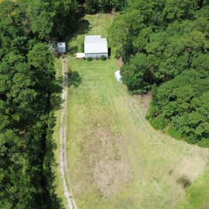 View of property location featuring a forest