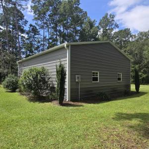 View of property exterior featuring a lawn