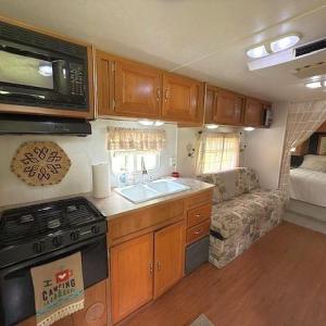 Kitchen featuring black appliances, brown cabinetr