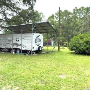 View of parking / parking lot with a carport and v