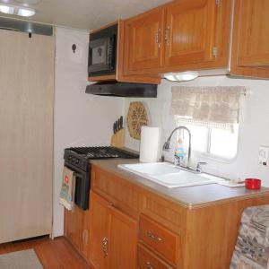 Kitchen featuring brown cabinetry, black microwave
