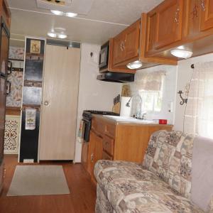Kitchen featuring dark wood-type flooring, brown c