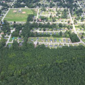 Aerial view of property's location with a forest