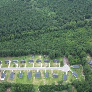 View of property location with a heavily wooded ar