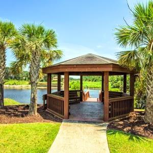 Dock with a gazebo, a deck with water view, and a