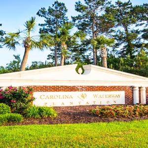 Community sign with a yard and a garage