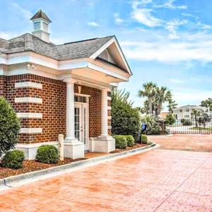 Doorway to property with brick siding, a porch, an