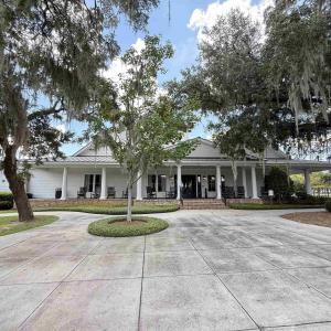 Farmhouse-style home with a large porch and curved