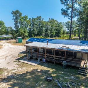 Rear view of property with a carport, a metal roof