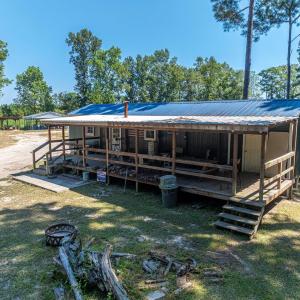 Back of property with a large porch, a yard, and a