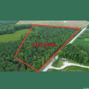 View of property location with a forest and proper