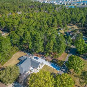 View of property location with a heavily wooded ar