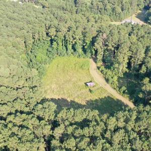 View of property location featuring a forest