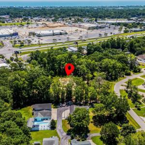 Aerial view of property's location featuring a tre