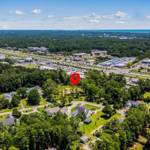 Aerial view of property's location with a tree fil