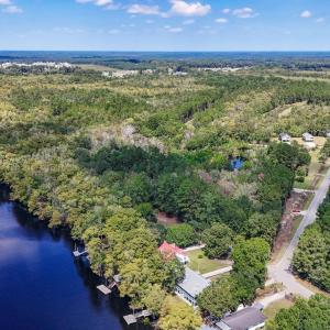 Aerial view of a heavily wooded area and a large b