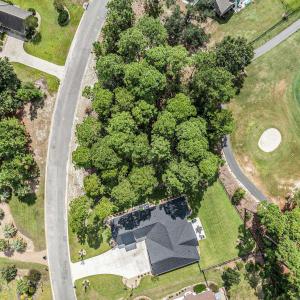 Aerial overview of property's location with a golf