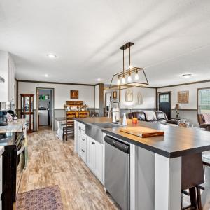 Kitchen with white cabinets, range with electric s
