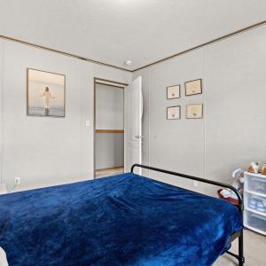 Bedroom featuring light carpet, a textured ceiling