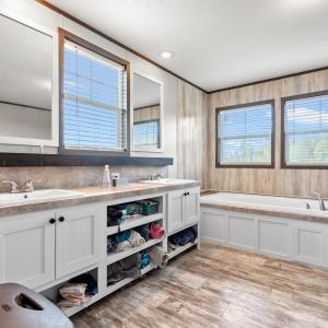 Full bathroom with a bath, double vanity, light wo