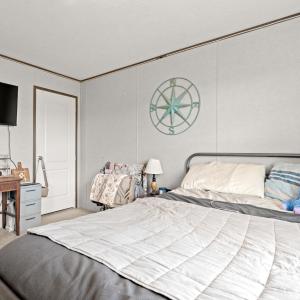 Bedroom with carpet, ornamental molding, and a des