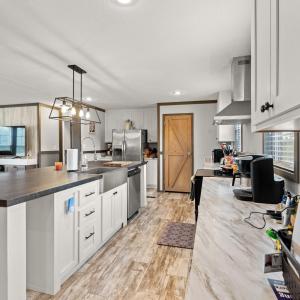 Kitchen with white cabinetry, a kitchen island wit