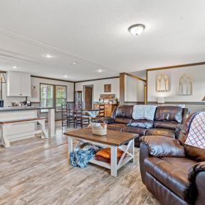 Living room featuring crown molding, light wood-st