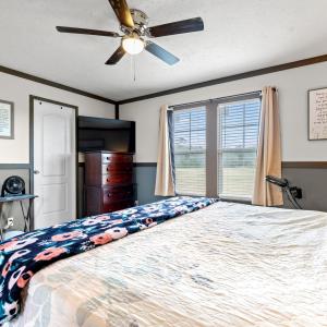 Bedroom with a textured ceiling, carpet floors, ce