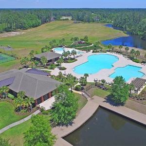 Drone / aerial view of a pool and a large body of