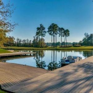 Dock featuring a water view and view of wooded are