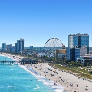 Water view featuring nearby beach and city skyline