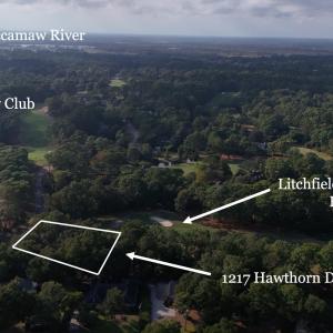 Aerial view of property's location with a forest a