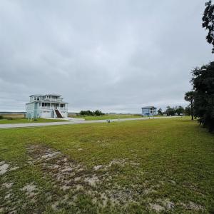 View of home's community with a yard