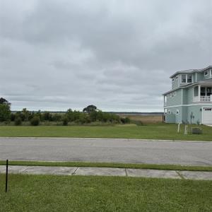 View of asphalt road featuring sidewalks