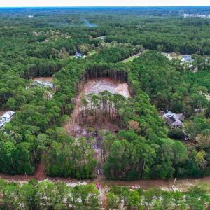View of property location with a heavily wooded ar