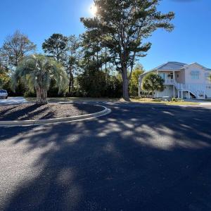 View of asphalt street featuring stairway, curbs,