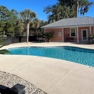 Community pool with a patio and an outdoor structu