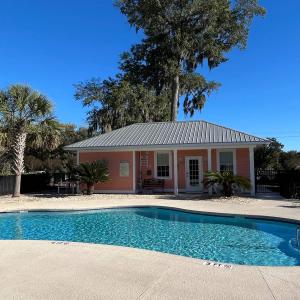 Community pool featuring a patio and an outdoor st