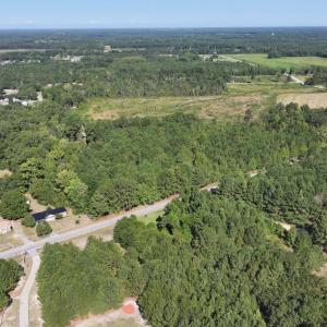 View of property location featuring a forest and r