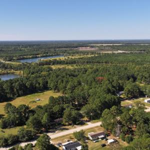 Aerial view of property's location with a forest a