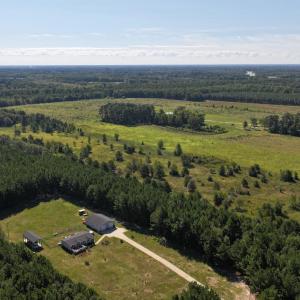 Aerial view of property's location with a forest