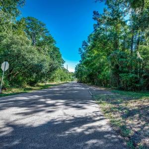 View of asphalt road featuring traffic signs