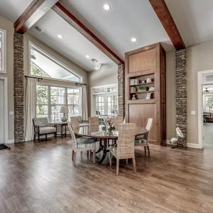 Living room with dark wood-type flooring, high vau