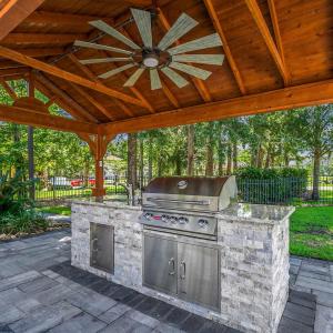 View of patio with area for grilling, a gazebo, a
