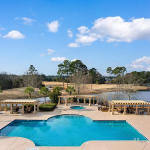 Community pool featuring a pergola and a patio are
