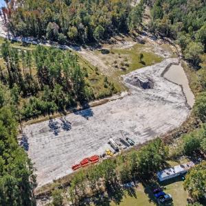 View of property location with a heavily wooded ar