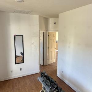 Exercise area with a textured ceiling, wood finish
