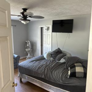 Bedroom featuring a textured ceiling, wood finishe