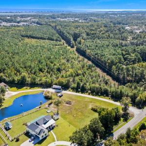 Aerial view of a nearby body of water and a forest
