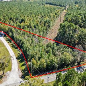 View of property location featuring a forest and p